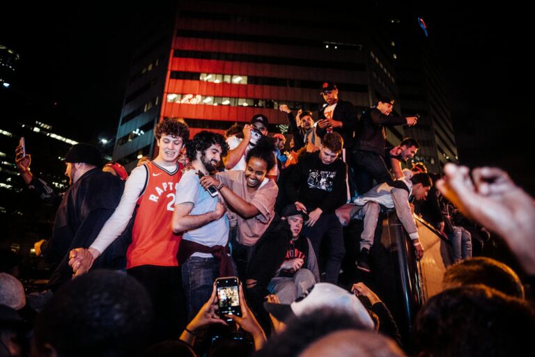 Energetic crowd celebrating a night event in the city with joyful togetherness.