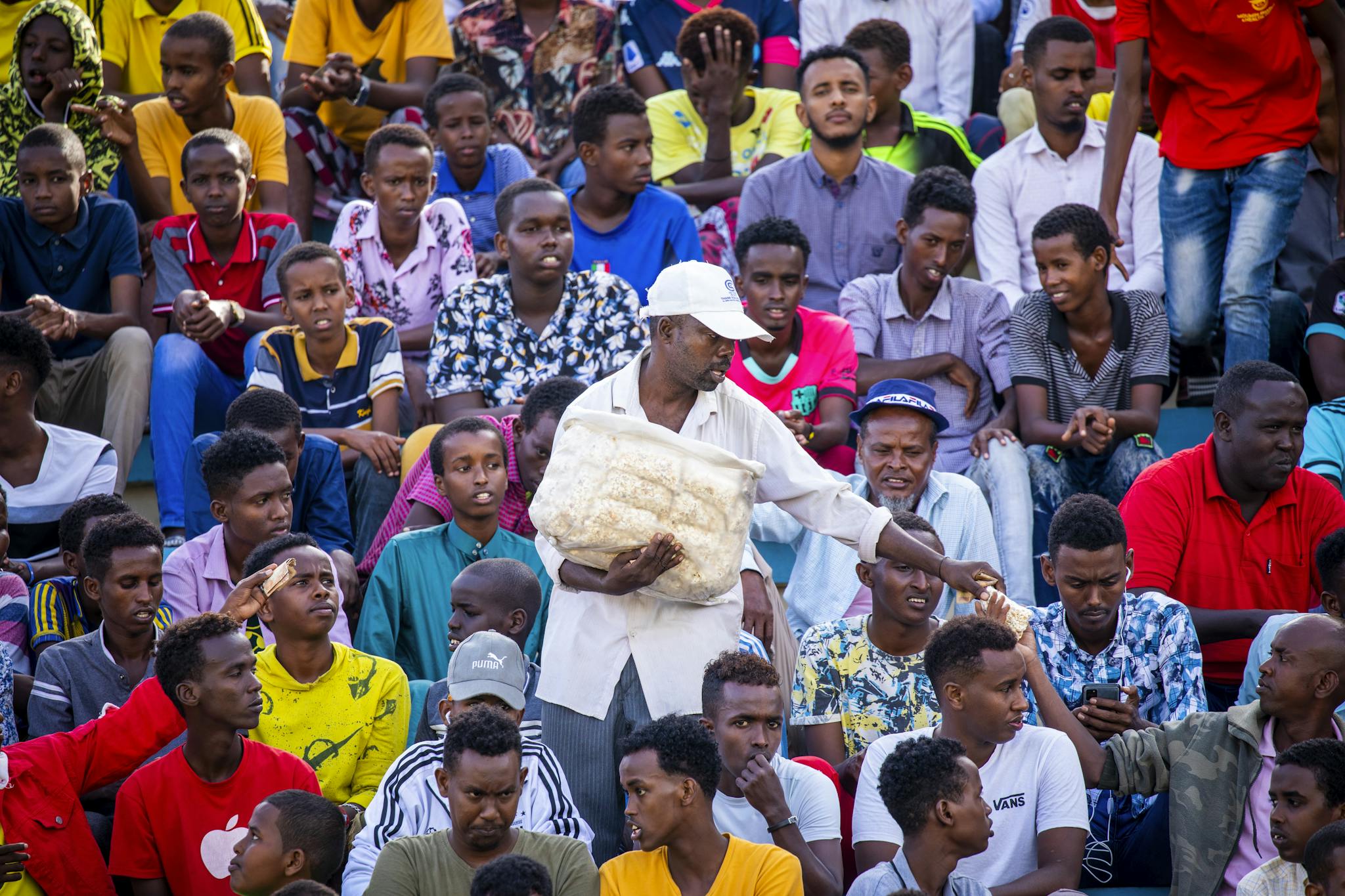 Engaged crowd in Mogadishu stadium, capturing lively audience interaction.